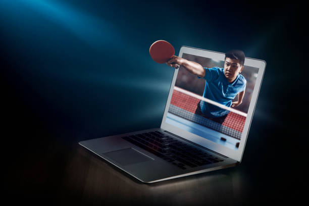 Ping pong on laptop. Live broadcast. Laptop on the table with Table tennis player that came to life. Asian player beats the ball