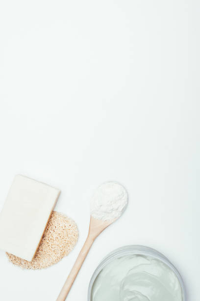 istock flat lay with soap, sponge, spoon, clay mask in container and clay powder isolated on white surface 983309468