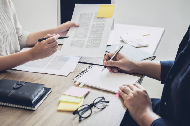 istock Young students campus or classmates with helps friend studying for a test an exam in workbook learning in classroom, Tutor books with friends, Education school concept 983321552