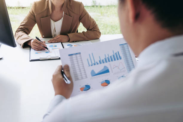 istock Business people conference, Two confident executive colleagues meeting and discussing, working in business strategy and financial plan to investment profit on graph and chart 983321884