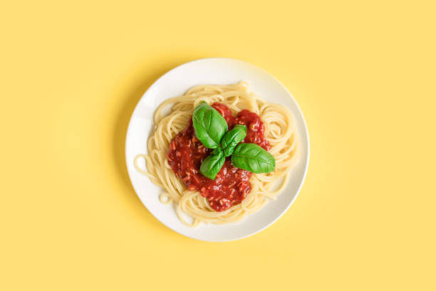 istock Spaghetti pasta bolognese on yellow 983331490