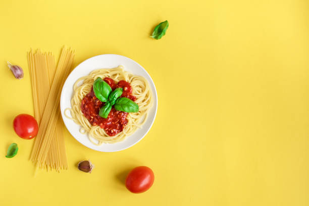 istock Spaghetti pasta bolognese on yellow 983331504