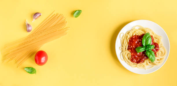 istock Spaghetti pasta bolognese on yellow 983331530