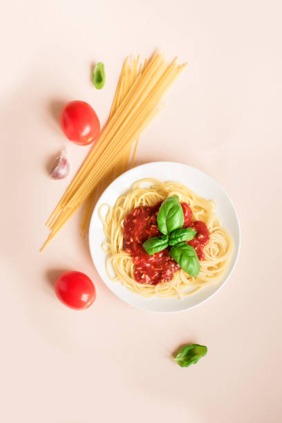 istock Spaghetti pasta bolognese on pink 983331534