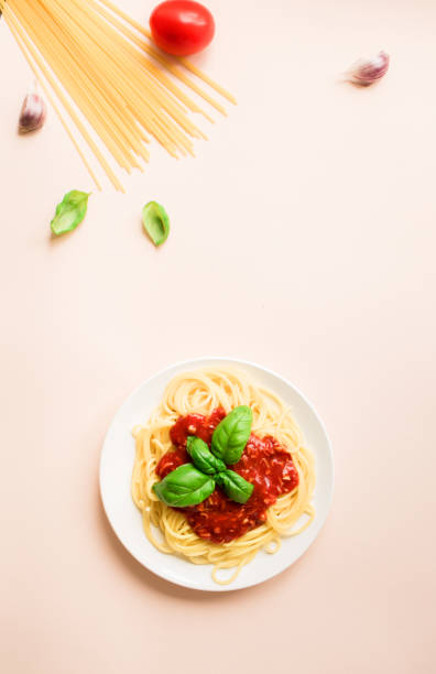 istock Spaghetti pasta bolognese on pink 983331542