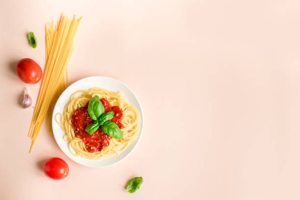 istock Spaghetti pasta bolognese on pink 983331554