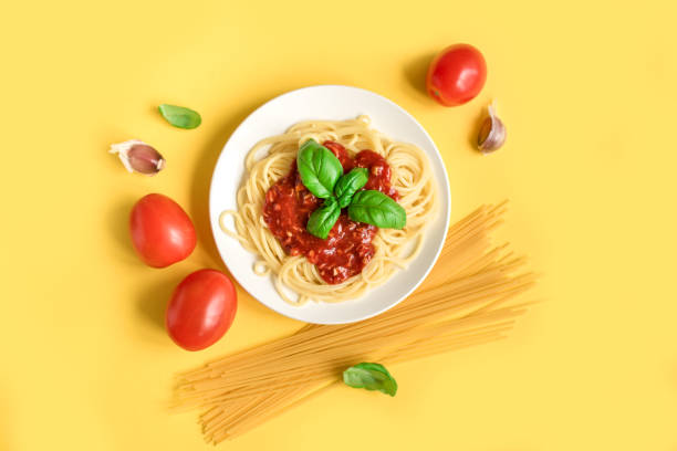 istock Spaghetti pasta bolognese on yellow 983331906