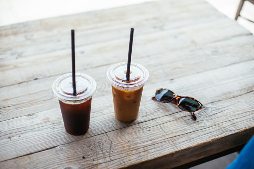 Two iced coffee on wooden table