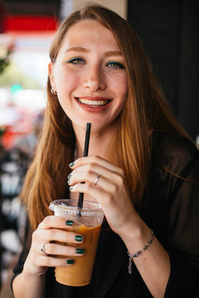 istock Smiling woman drinking iced coffee 983337198