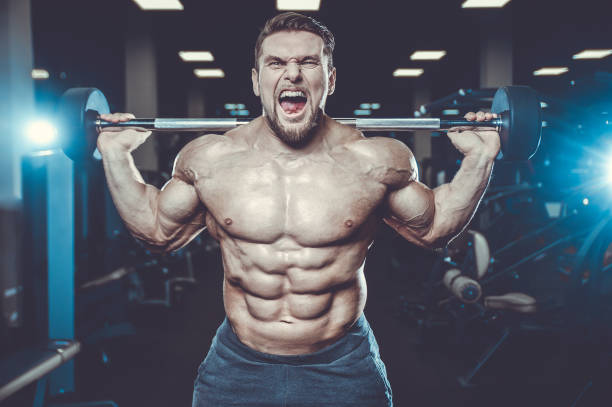 istock Handsome model muscle man abs workout in gym 983337556
