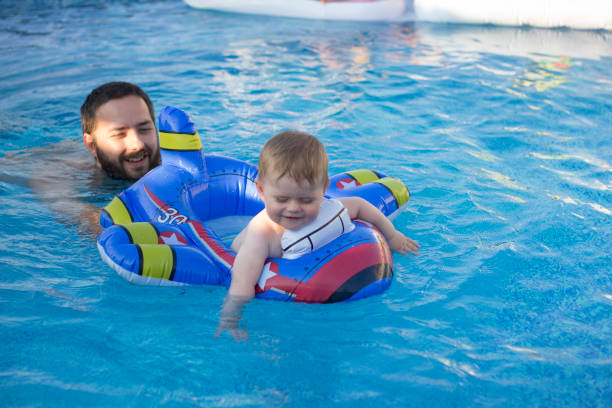 istock Cruising The Pool With Dad 983343540