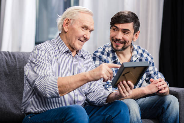 istock Positive father and son looking at a photo frame 983347228