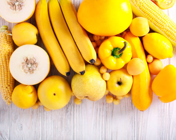 istock Yellow color assorted vegetables and fruits 983347232