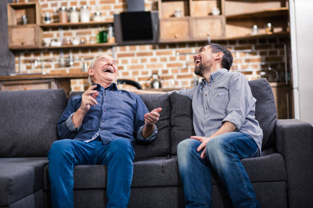 istock Cheerful aged man cracking jokes with his son 983350518
