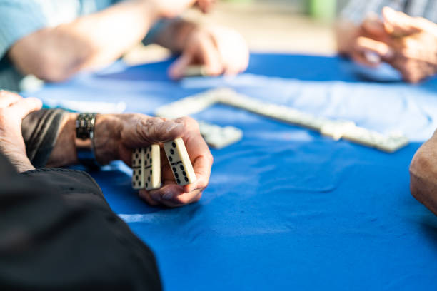 istock Close-up of Senior Hands Playing Domino Game 983355826