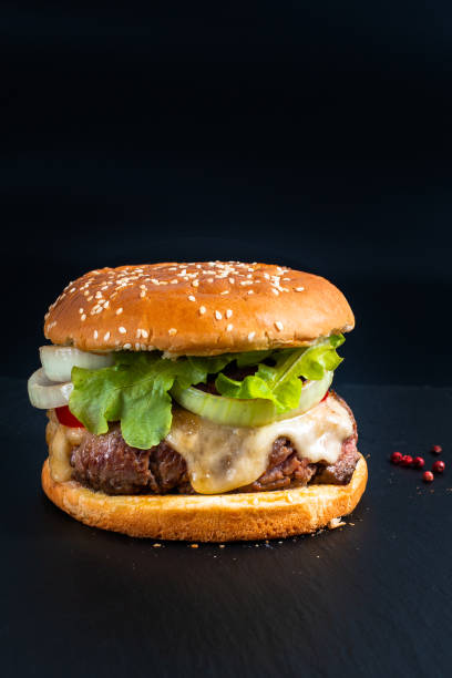 istock Food concept Homemade Hamburger on black slate plate with copy space 983359092