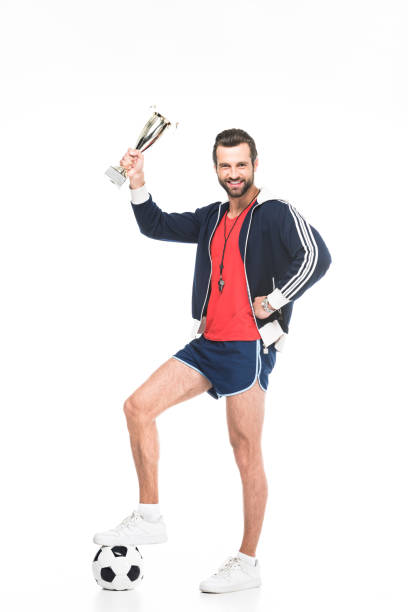 istock football coach with trophy cup and ball, isolated on white 983364210
