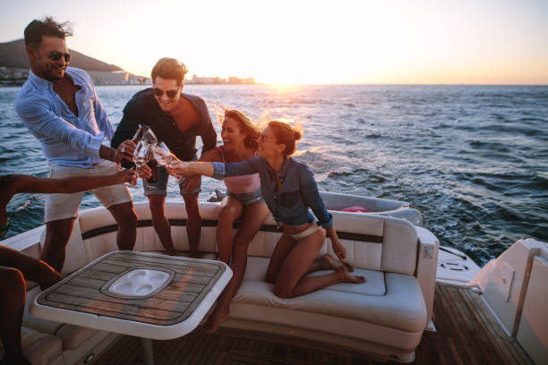 istock Young people having a boat party at sunset 983370908