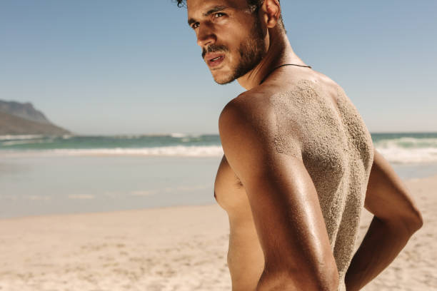 istock Man standing at the beach doing fitness training 983371562