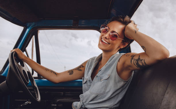 istock Woman with sunglasses driving a car. 983376718