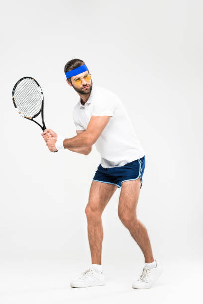 istock tennis player in retro sunglasses training with racket, isolated on white 983376768