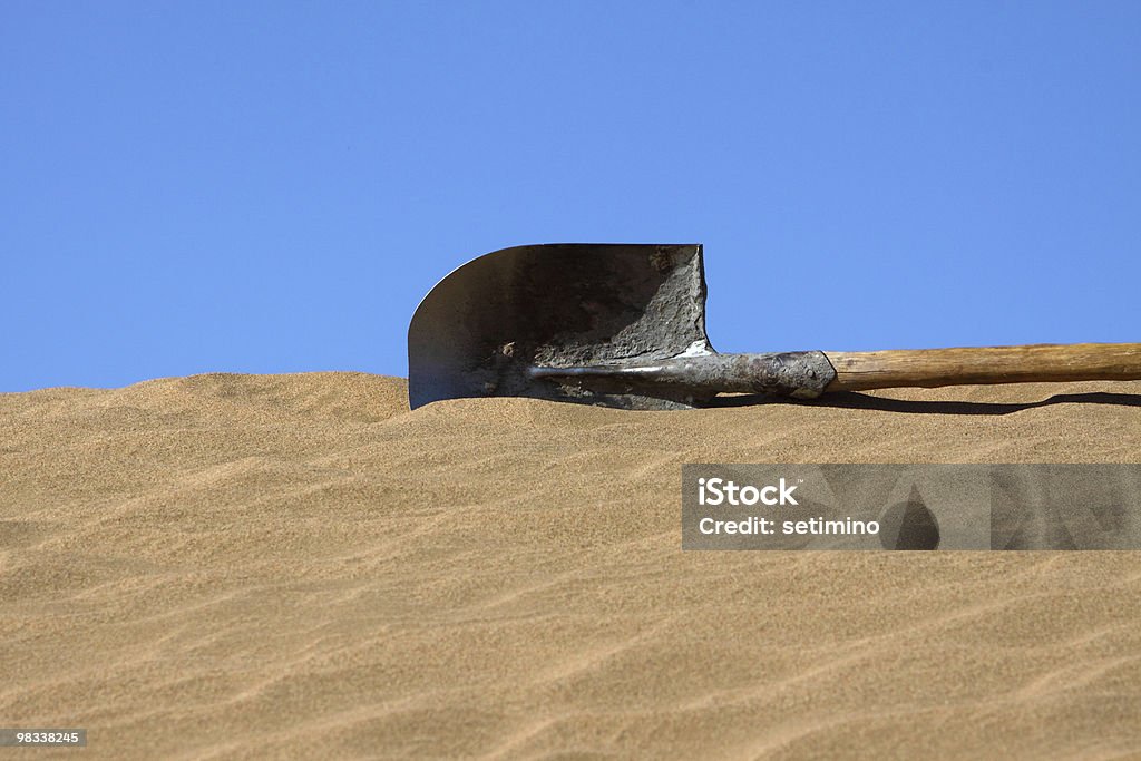 spade in sand  Lying Down Stock Photo