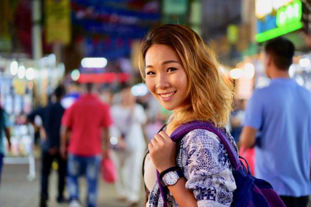 istock Attractive Asian female Student exploring Asian night market 983399226