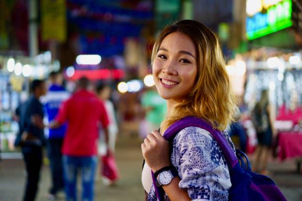 istock Attractive Asian female Student exploring Asian night market 983399266