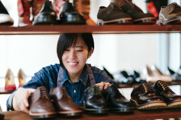 istock Woman working at shoe store 983411600