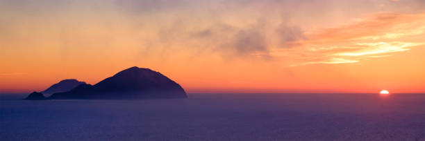 Filicudi and Alicudi at sunset seen from Salina (Aeolian Islands, Sicily, Italy) Filicudi and Alicudi at sunset seen from Salina (Aeolian Islands, Sicily, Italy) filicudi stock pictures, royalty-free photos & images