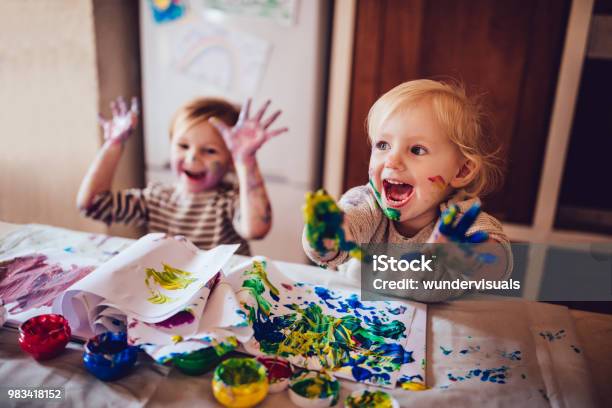 Cheerful Little Children Having Fun Doing Finger Painting Stock Photo - Download Image Now