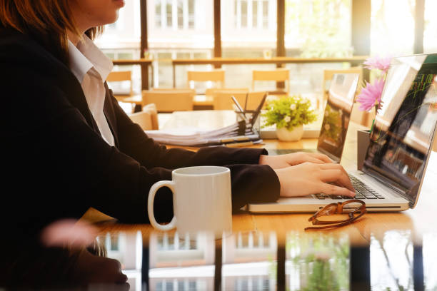 istock Business woman using computer to planning financial data in workplace with close up shot. 983420966