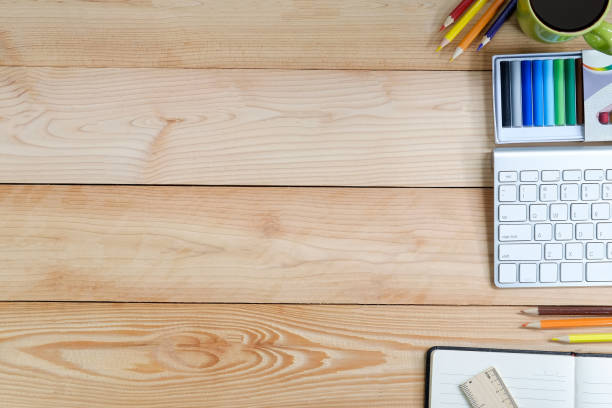 istock Workspace with computer, colour pencil notebook and coffee cup on wooden desk. 983421656