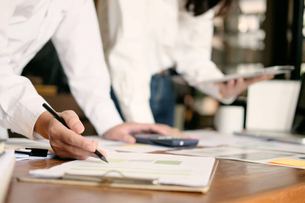 istock Business team working with finance paper data on office table with vintage tone. 983421778