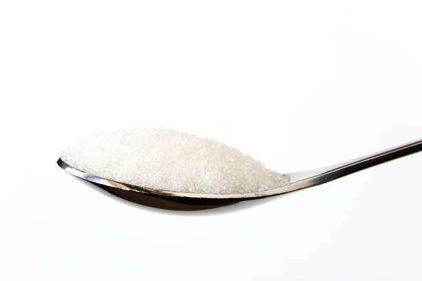 istock Sugar sand on a spoon on a white background. 983425294