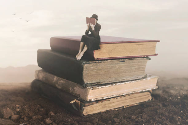 Surreal image of a woman reading sitting on top of a book stock photo