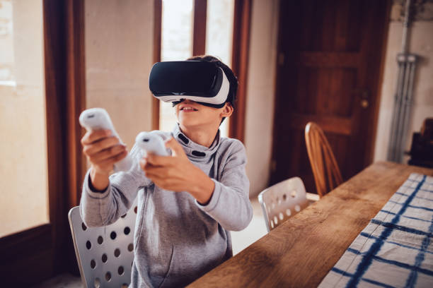 Boy with virtual reality simulator playing augmented reality game Boy with virtual reality simulator headset playing futuristic augmented reality video game at home 1528 stock pictures, royalty-free photos & images