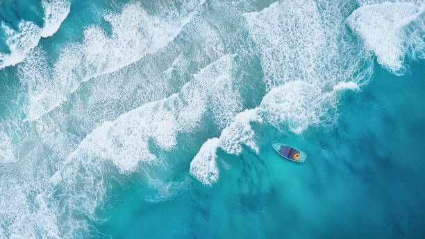 istock Wave and boat on the beach as a background. Beautiful natural background at the summer time from air 983429220