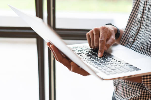 istock close up businessman type on laptop for working or checking email form internet , business technology concept 983430012