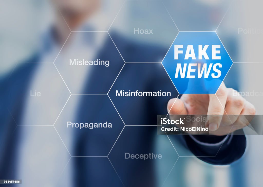 Fake News concept with a person showing misleading, deceptive stories, propaganda, lies, fabricated facts to control or manipulate opinion on internet and social media, political elections Misinformation Stock Photo