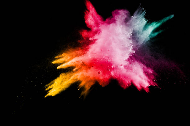 istock Multi color particles explosion on black background. Colorful dust splatter on dark background. 983457804