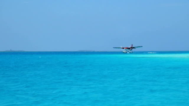 Seaplane makes landing on water. Maldives Indian Ocean.
