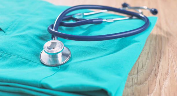 istock Stethoscope on a table with medical uniform 983462756