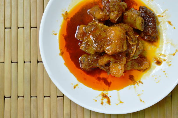 istock spicy stir fried pork bone with pineapple curry 983471494