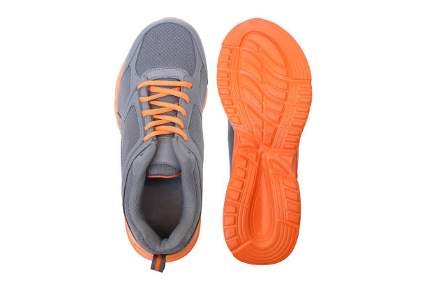 Running shoes Running shoes with grey and orange colors sole of shoe stock pictures, royalty-free photos & images