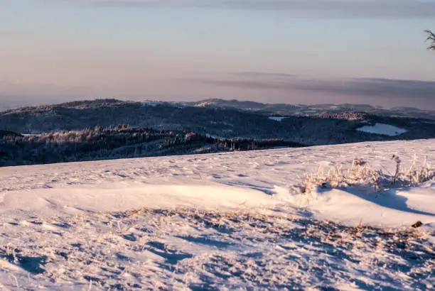 view from Ochodzita hill above Koniakow village in Beskid Slaski mountains during winter morning with snow and blue sky