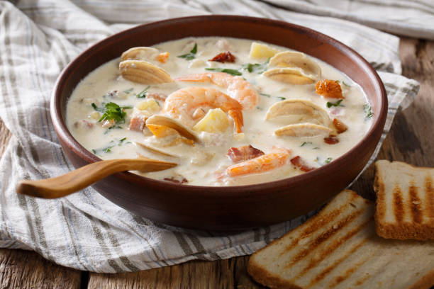 istock Thick milky Clam chowder soup close-up. horizontal 983505964