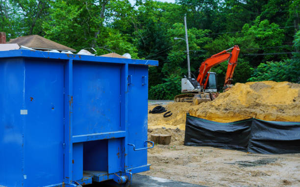 istock Blue metal waste container with building debris for recycling. 983511334