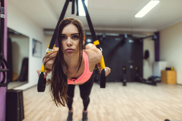 istock Woman working out on suspension equipment 983520814