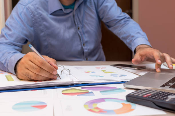istock Close up of businessman working in his office and taking notes 983544516